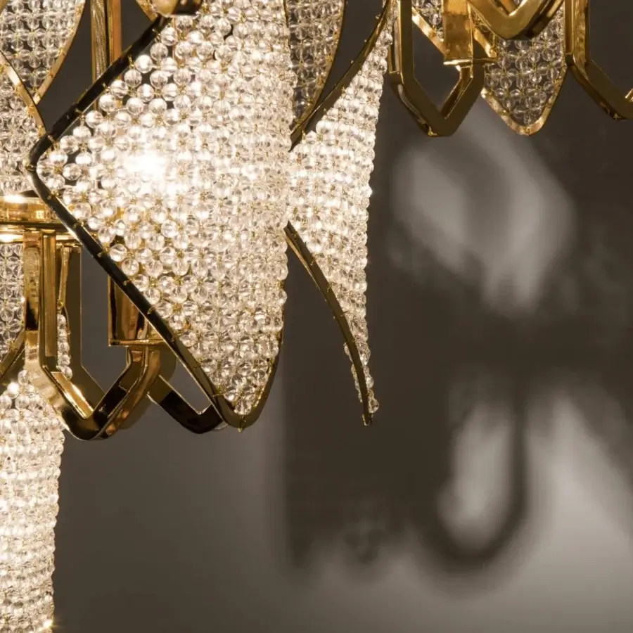 Lavish Patrizia Garganti Holly Units chandelier in glossy gold-toned metal crafted with luminous clear crystal elements