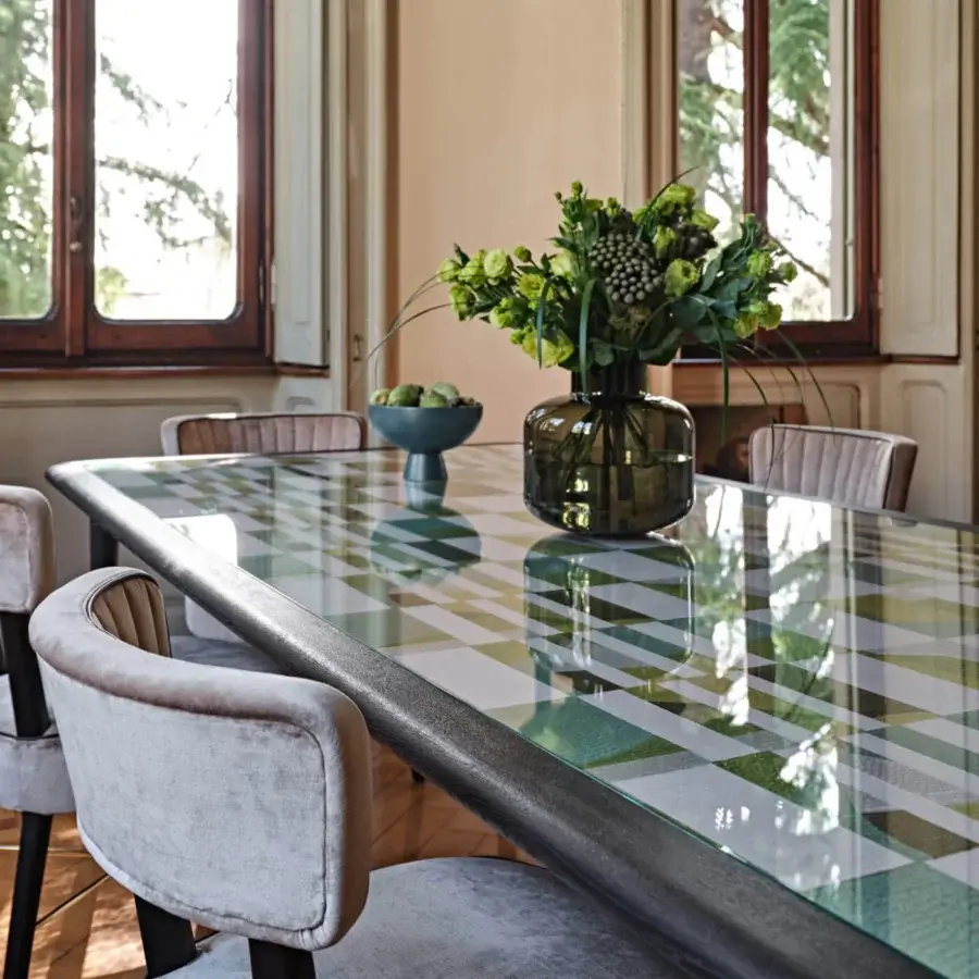 Exceptional Black Tie Caius table with clear glass tabletop displaying a green and white grid and sleek dark metal support