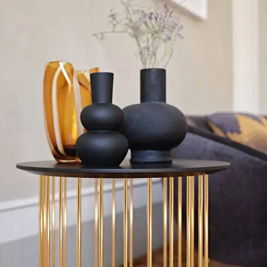 Sophisticated Black Tie Etan side table with black-lacquered tabletop and slender golden metal rods creating airy lightness