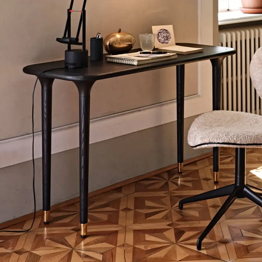 Superior Black Tie Livia console crafted in wood with a satin black finish and delicate gold conical legs