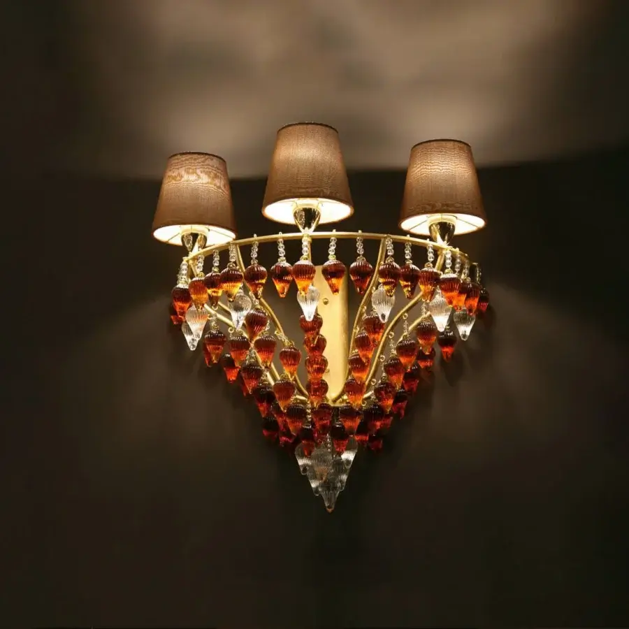 Exceptional Patrizia Garganti Ophelia wall lamp with amber and orange glass prisms, clear crystal accents, and a polished golden-toned metal frame