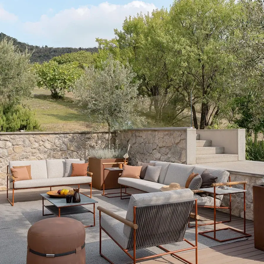 Elegant Atmosphera Pipe lounge chair with terracotta epoxy-coated steel, teak armrests and hand-woven acrylic cord backrest