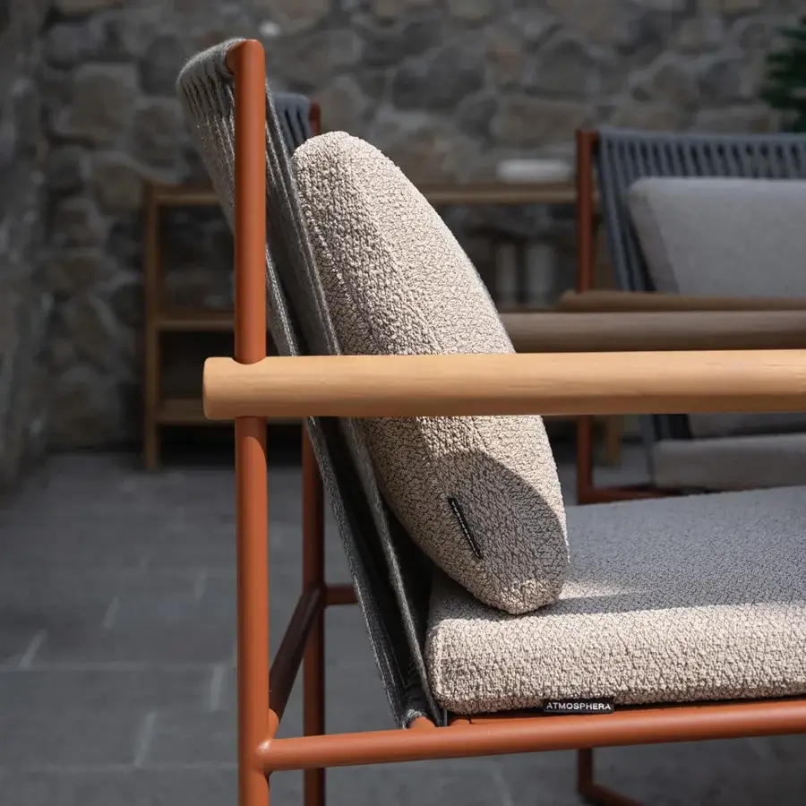 Distinguished Atmosphera Pipe armchair with terracotta epoxy-coated steel, hand-woven beige acrylic cords and natural teak armrests