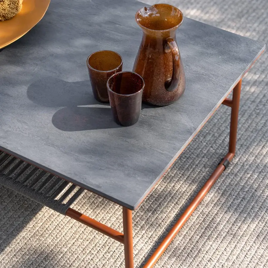 Elegant Atmosphera Pipe coffee table with medium gray gres tabletop and terracotta epoxy powder-coated steel frame built with woven grey rope