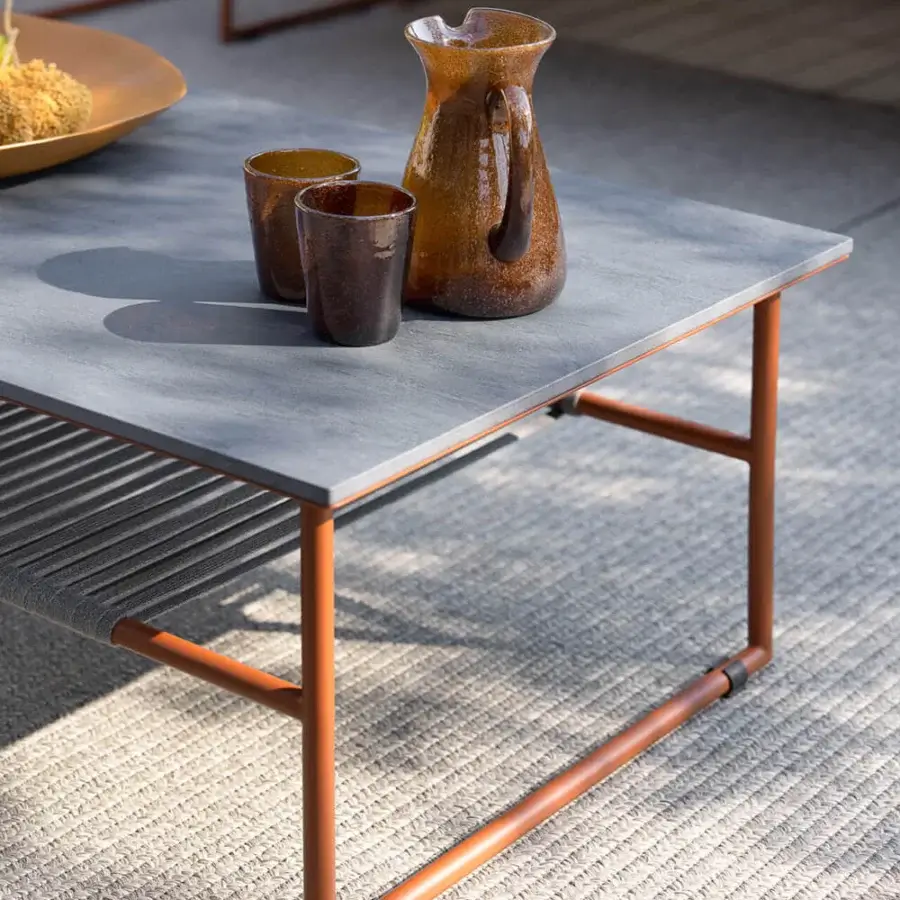 Distinguished Atmosphera Pipe coffee table with muted gray gres tabletop and terracotta epoxy powder-coated steel frame built with woven grey rope