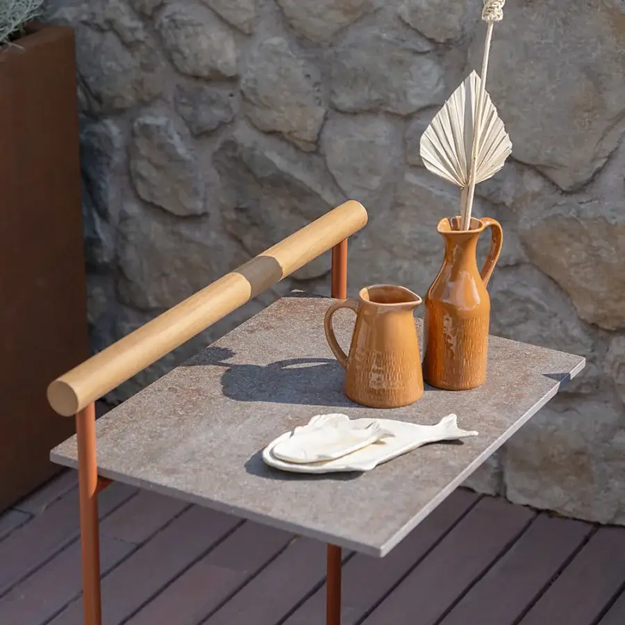 Superior Atmosphera Pipe side table with a gres stoneware tabletop and terracotta-finished steel frame including a teak handle