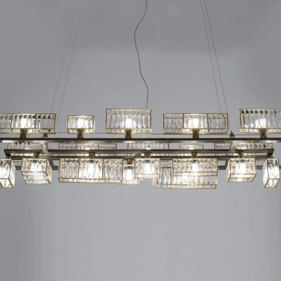 Elegant Patrizia Garganti Tur chandelier crafted in satin brass-toned metallic structure with transparent crystal lozenges