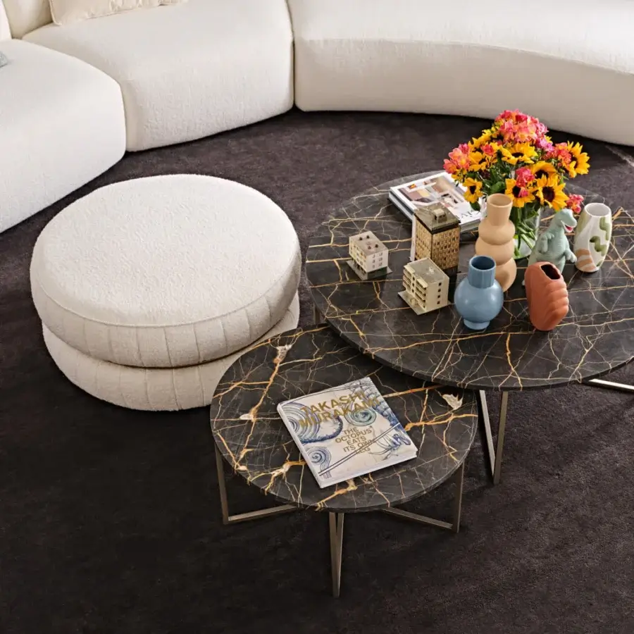 Distinctive Black Tie Lillo ottoman with cream textile upholstery, silver-toned metal base, and dark brown marbled stone inlay