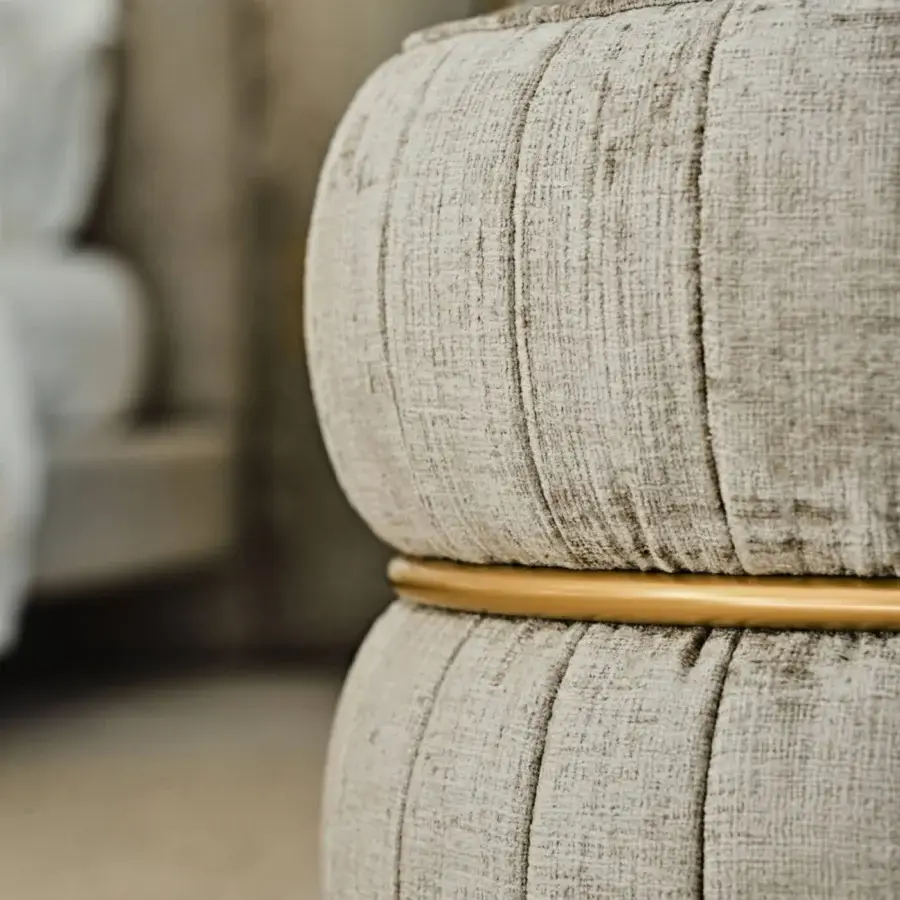 Superior Black Tie Lillo ottoman with textured beige textile upholstery and brass-toned metal band detailing