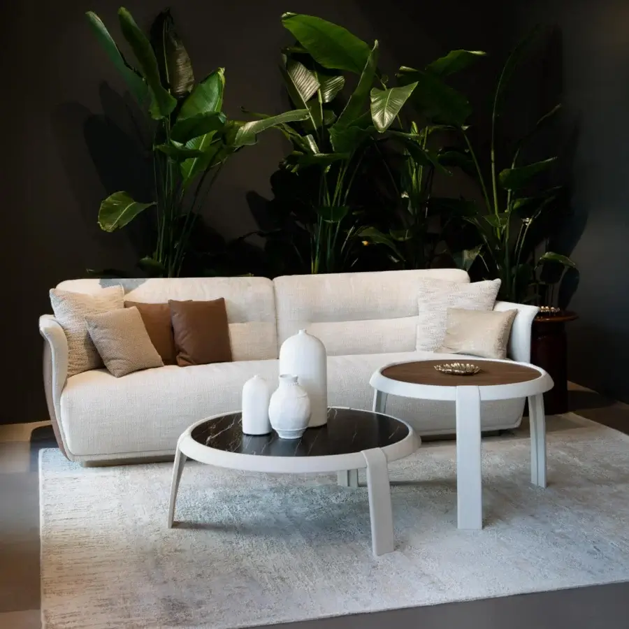 Elegant Capital Omega coffee table with round marble tabletop and sleek white leather-clad frame