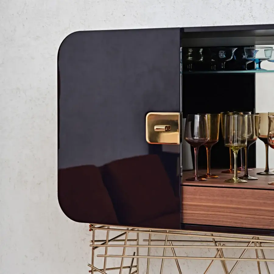 Exclusive Black Tie Mai Tai bar cabinet crafted with curved plywood and lacquered MDF, featuring a stainless steel base and handle