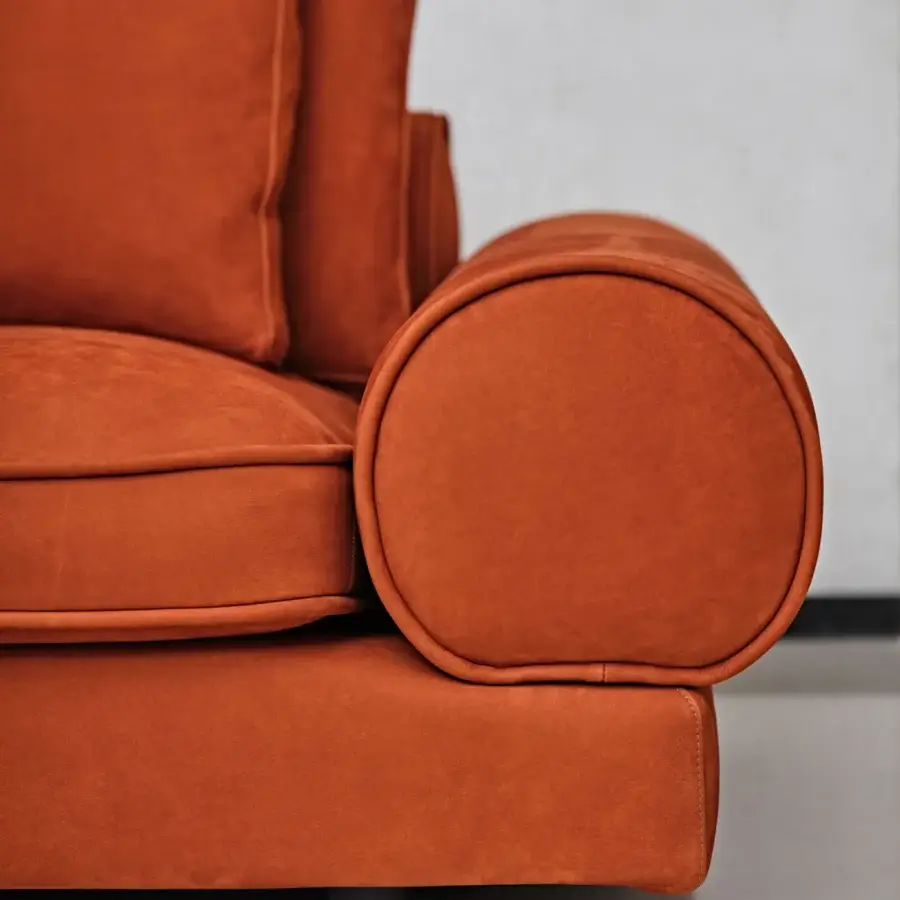 Distinguished Black Tie Sebastian sofa with enveloping curves and textured matte velvet upholstery in warm orange tones