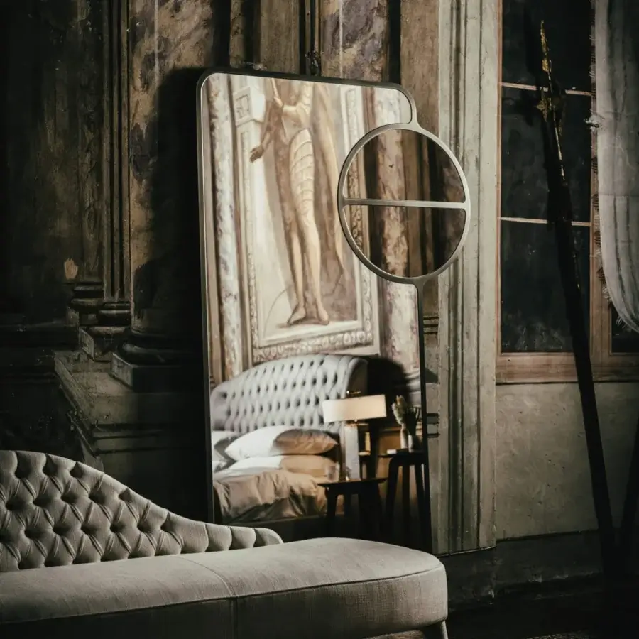 Elegant Black Tie Mou mirror crafted in Italy with dark bronze metal and a circular accent
