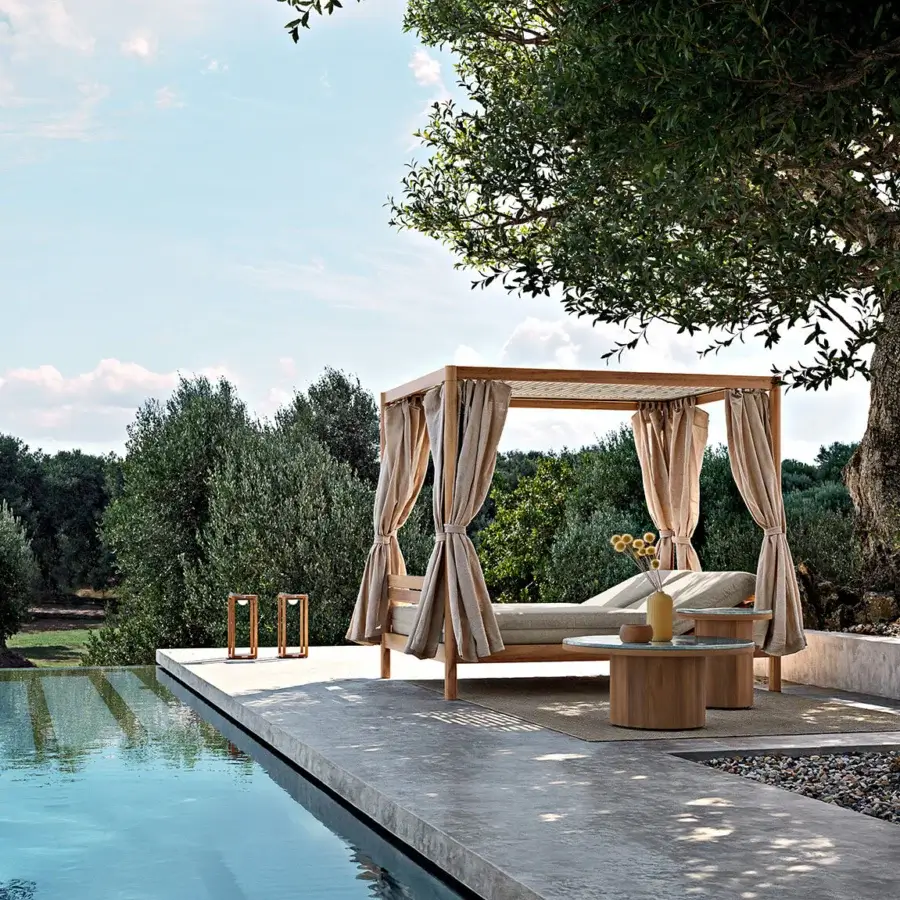 Distinguished Atmosphera Panama daybed crafted with solid teak, perforated white aluminum roof and light-beige draping curtains
