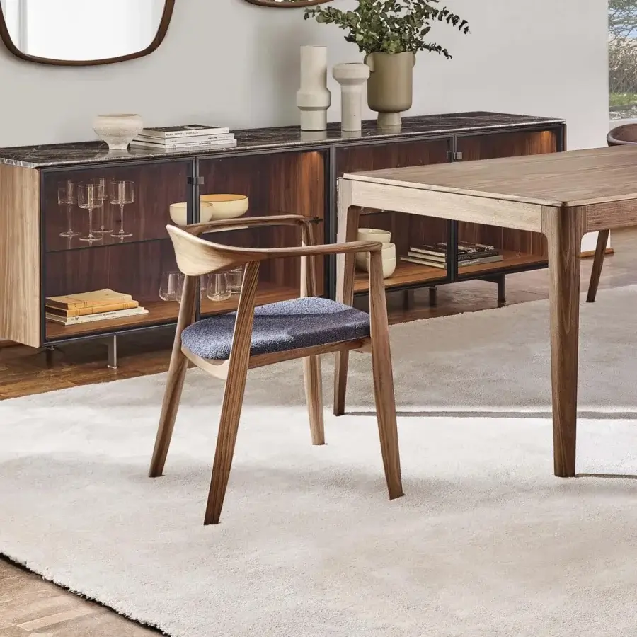 Elegant Porada Frida armchair with sculpted solid canaletto walnut frame and muted blue-grey textured woven fabric seat