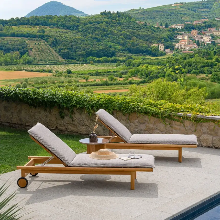 Distinguished Atmosphera Panama lounger with sculpted teak structure and light gray textured slats exhibiting a satin finish