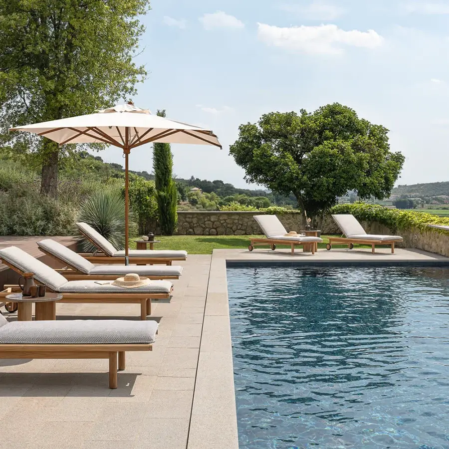 Superior Atmosphera Panama lounger with substantial teak frame and neutral beige-grey textile offering relaxed comfort with integrated wheels