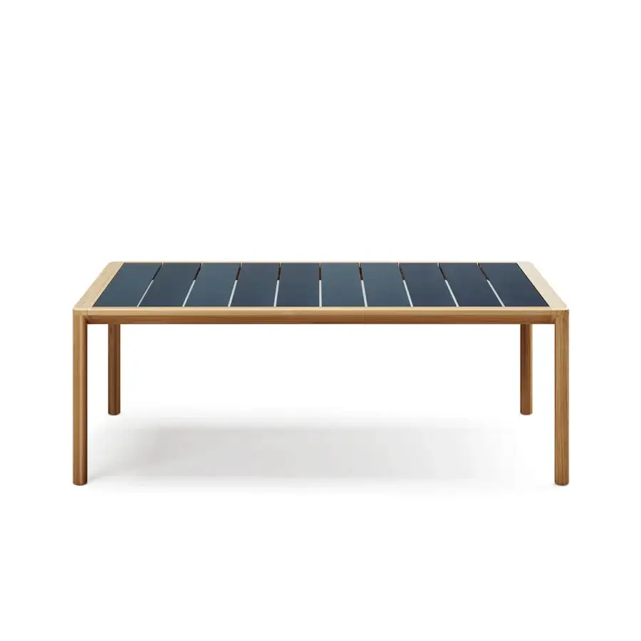 Distinguished Atmosphera Panama table crafted with teak and ceramicized lava stone in a dark blue-grey hue with precise groove detail