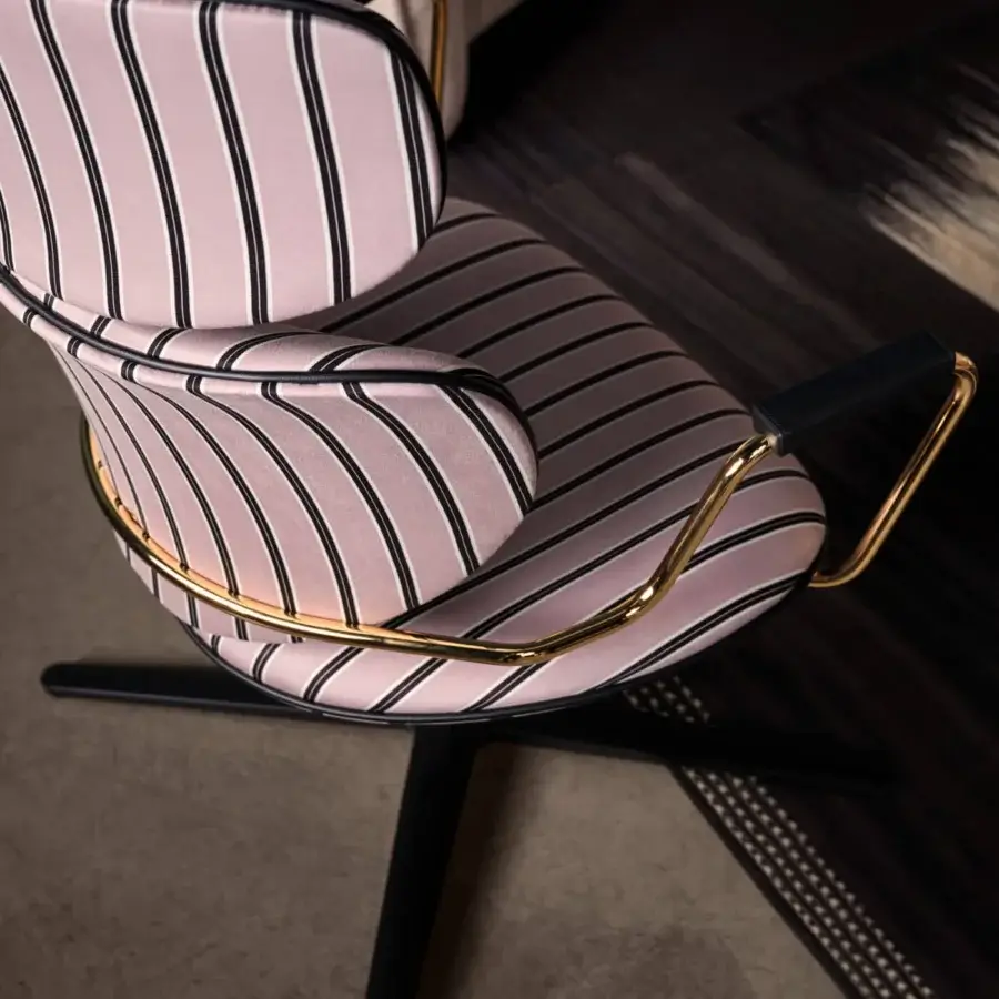 Distinguished Black Tie Asia swivel lounge chair upholstered in pale pink and black striped textile with a polished metal base