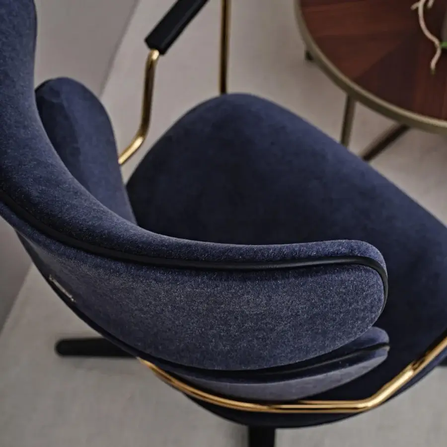 Elegant Black Tie Asia swivel lounge chair upholstered in deep navy blue textured textile with a polished golden metallic frame