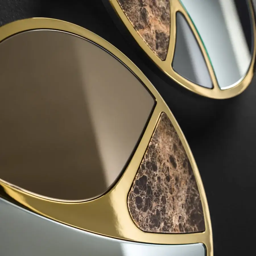Distinguished Black Tie Delta mirrors crafted in Italy with Emperador marble and polished gold-tone metal framing overlapping curved shapes