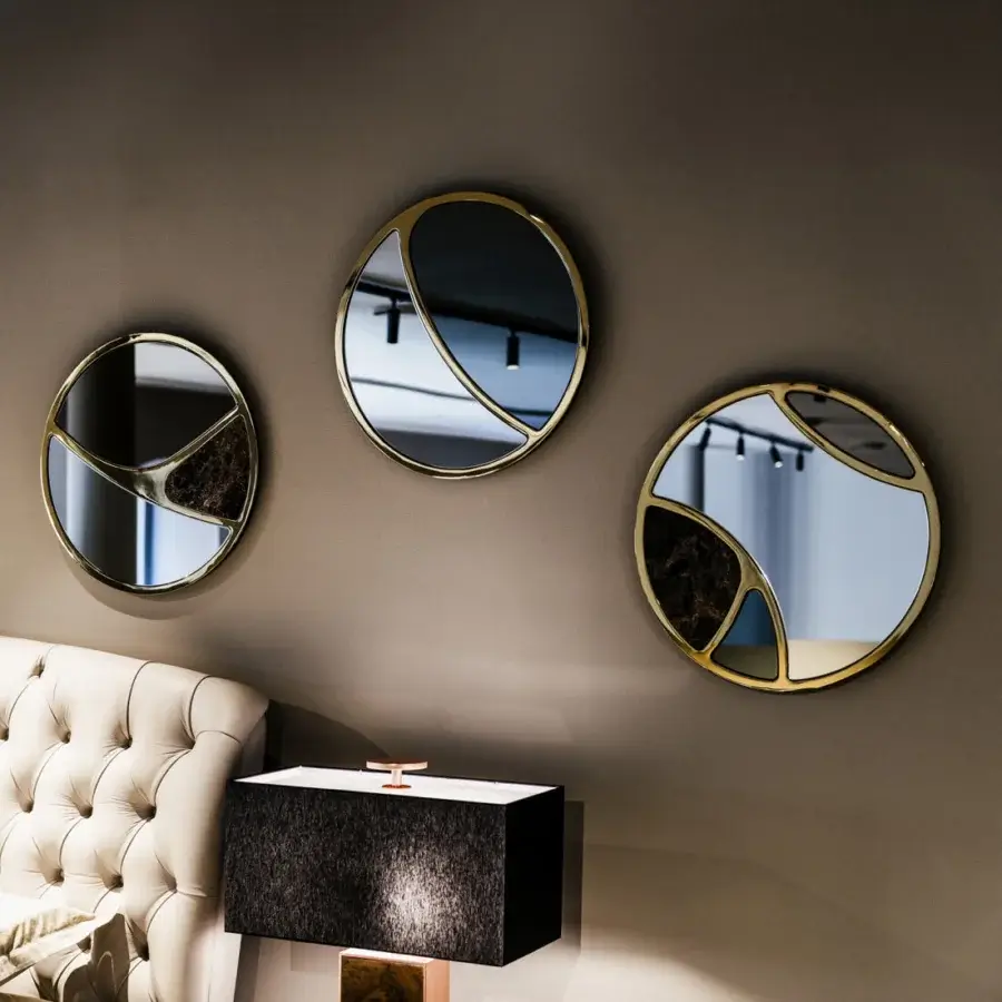 Superior Black Tie Delta mirrors crafted with golden-toned metal and mirrored glass, exhibiting fragmented circular forms with dark textured backing