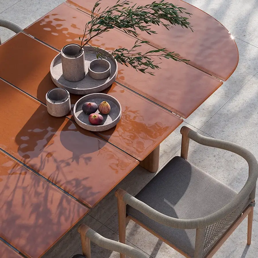 Superior Atmosphera Materia table built with subtly textured glass and a glossy Asian Teak base exhibiting warm orange gradients