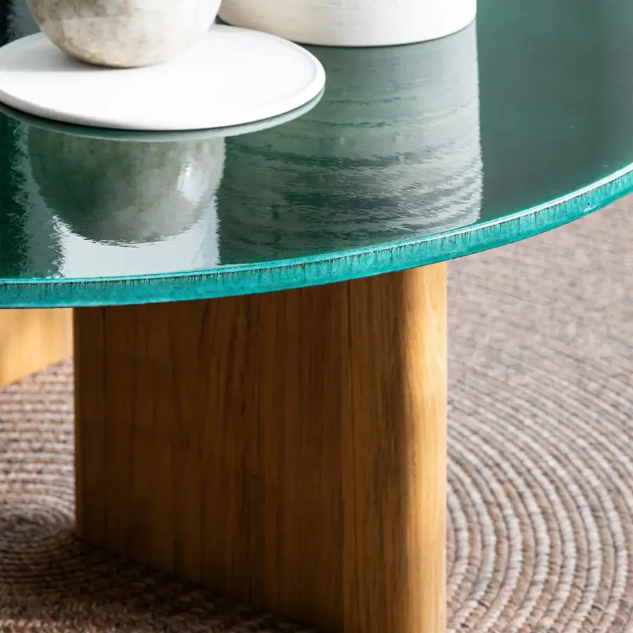 Distinguished Atmosphera Materia coffee table built with sculpted Asian Teak and glossy glazed teal lava stone tabletop