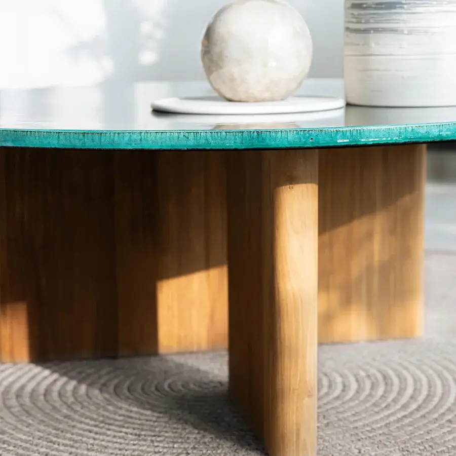 Distinctive Atmosphera Materia coffee table built with sculpted Asian Teak and glossy glazed teal lava stone tabletop