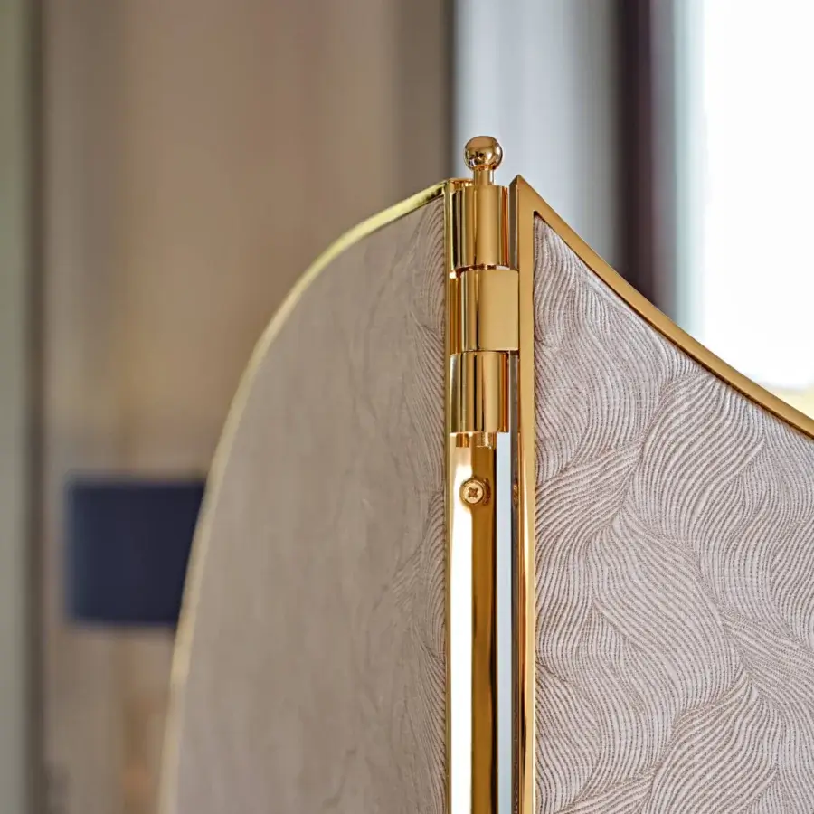 Lavish Black Tie Aliseo room divider built with textured light beige fabric and glossy gold-toned metal frame