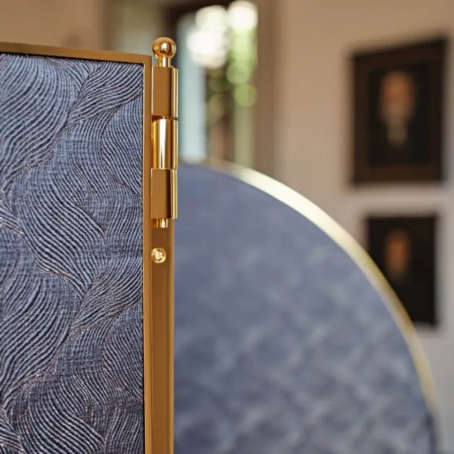 Superior Black Tie Aliseo room divider crafted in textured muted blue fabric with polished golden-toned metal framing