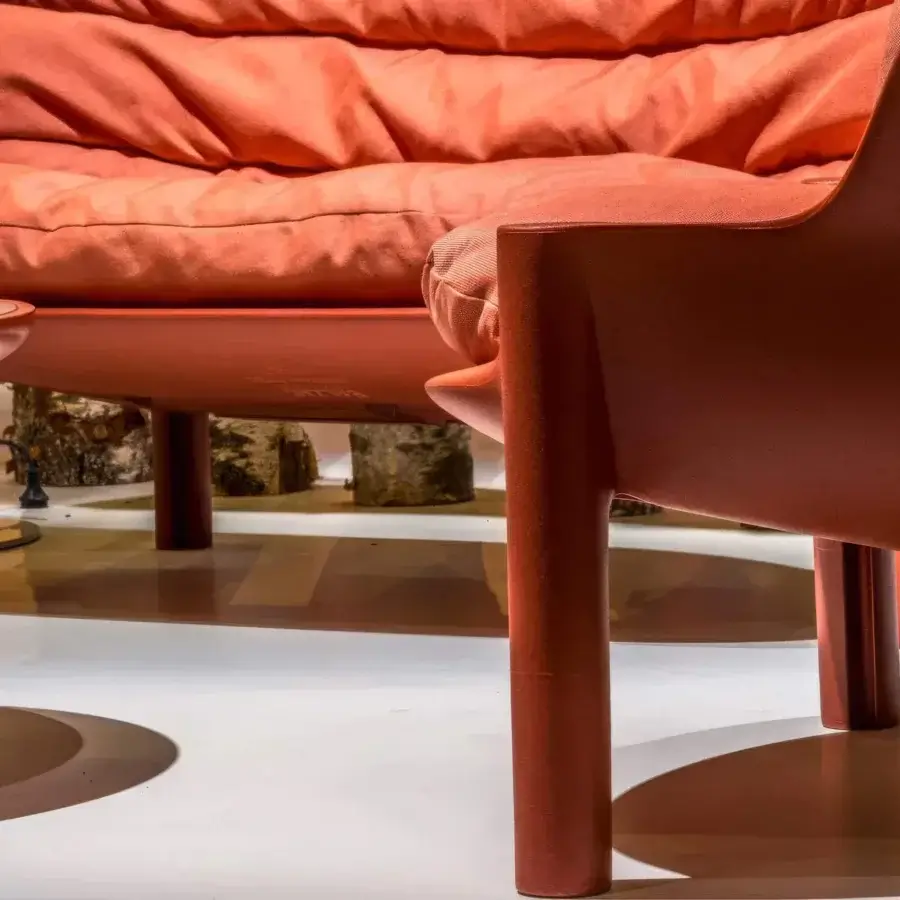 Elegant Serralunga Balzac sofa with a curved form crafted in terracotta recyclable LLDPE plastic with quilted cushions