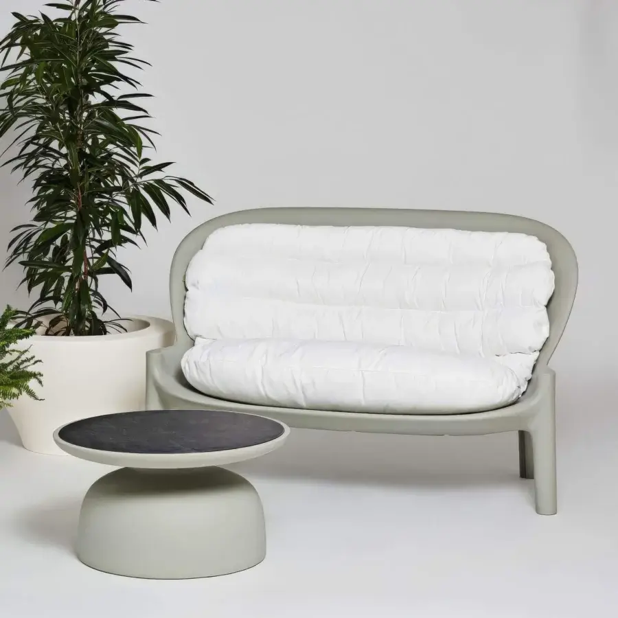 Exceptional Serralunga Balzac sofa with a curved form built in LLDPE and a matte muted grey-green finish complemented by plush white cushions