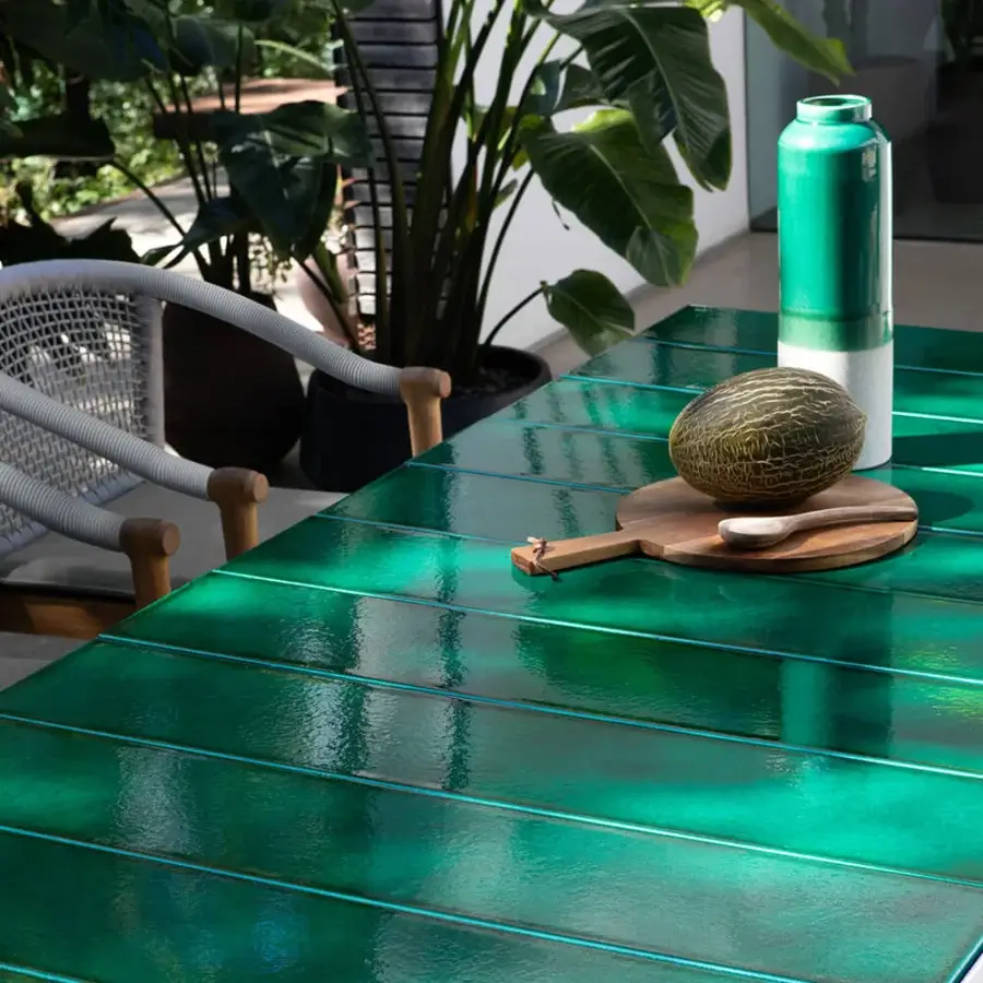 Elegant Atmosphera Pantagruel table with a glossy teal ceramic surface and solid aluminum base
