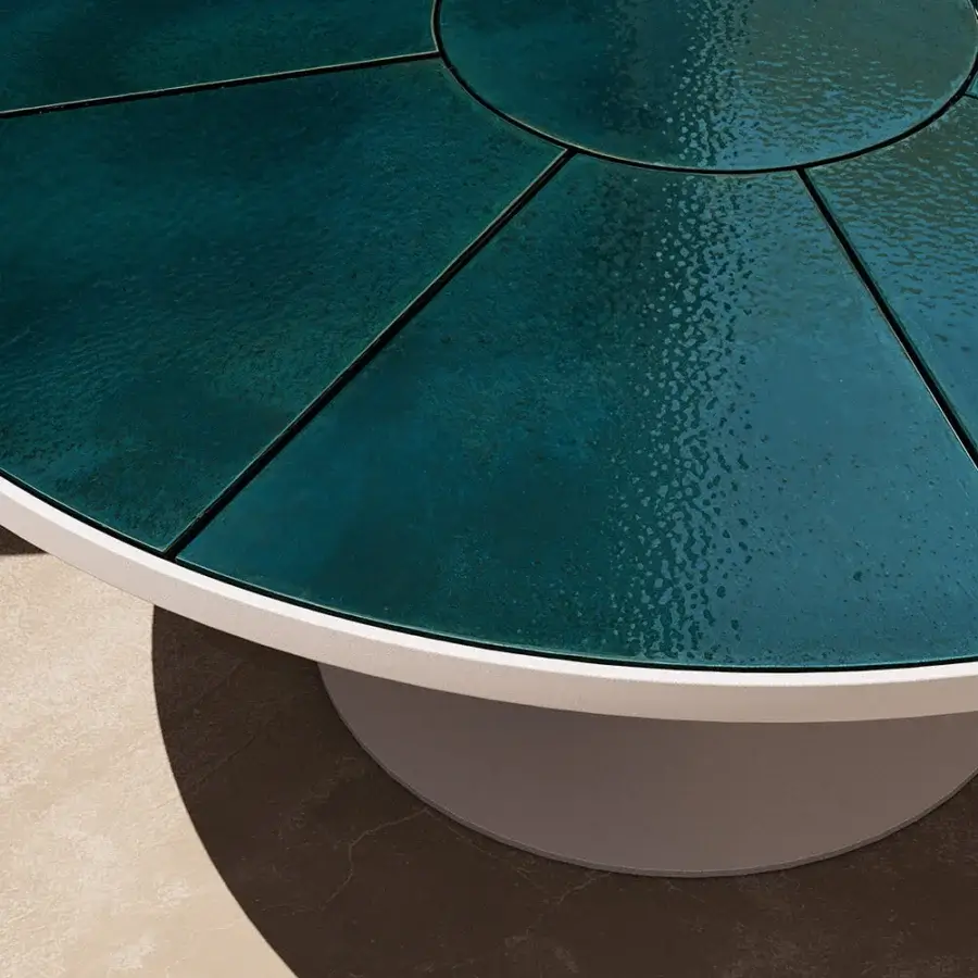 Distinguished Atmosphera Pantagruel round table with a glossy glazed lava stone tabletop in deep teal and off-white aluminum base