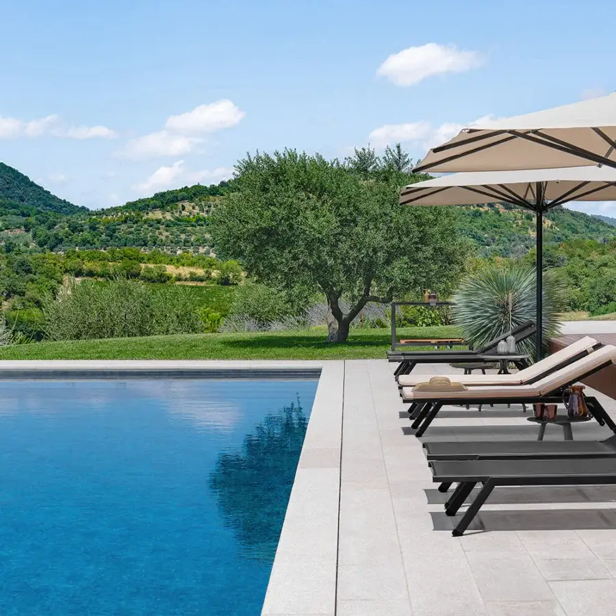 Elegant Atmosphera Maxim chaise lounge built with aluminum and breathable micro heat-sealed Textilene in dark brown or charcoal tones with epoxy finish