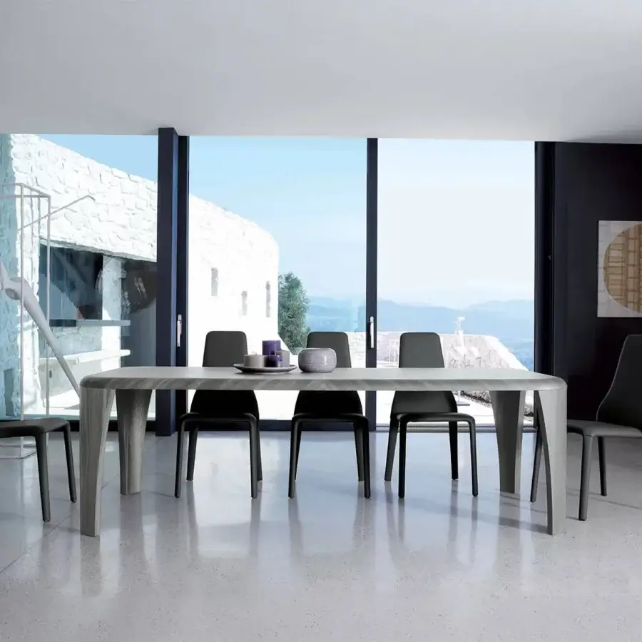 Distinguished Ivano Antonello Italia dining table with a wide rectangular surface and subtly angled legs in a medium grey-brown wood veneer with a refined matte finish