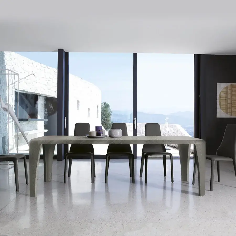 Exceptional Ivano Antonello Italia Igor dining table crafted in wood veneer exhibiting gently curved lines and a muted gray-brown tone