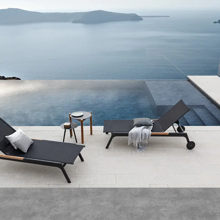 Elegant Atmosphera Nevada chaise lounge with graphite aluminum and dark gray textile offering teak accents