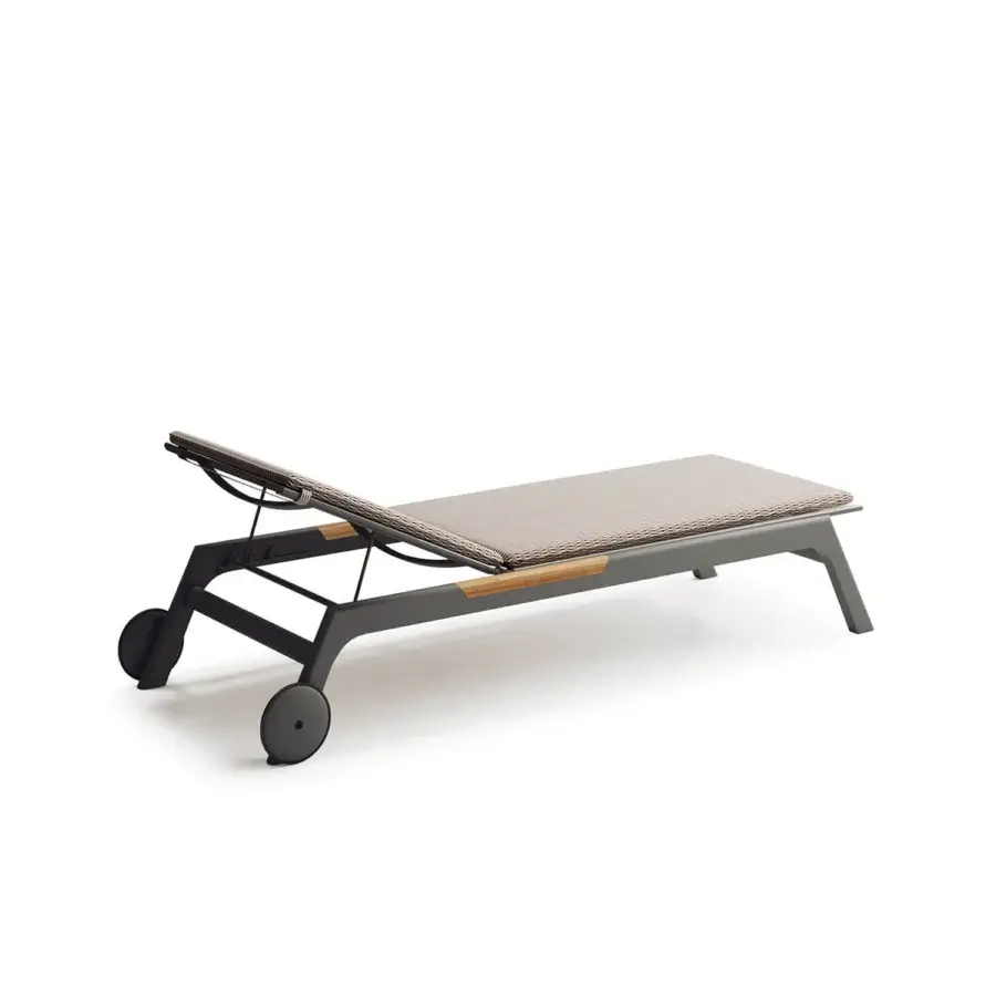 Distinguished Atmosphera Nevada chaise lounge built with graphite aluminum, teak inserts and a neutral beige woven textile surface