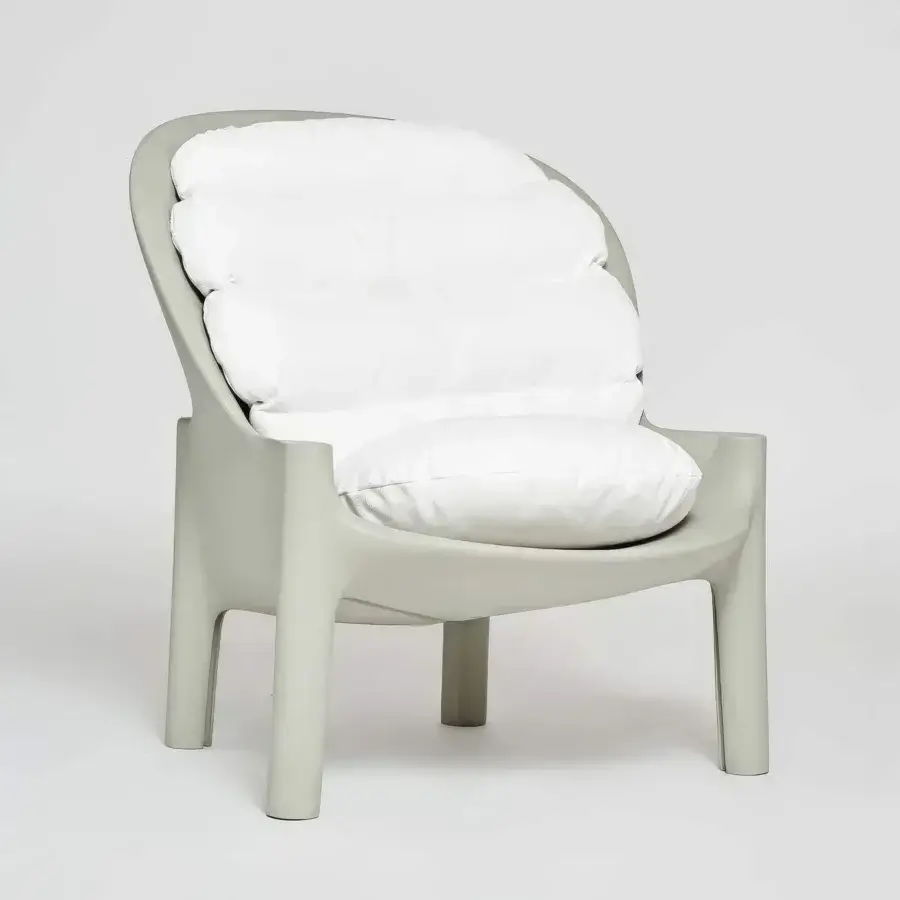 Refined Serralunga Balzac lounge chair with enveloping shape crafted in matte light grey-green recyclable LLDPE plastic