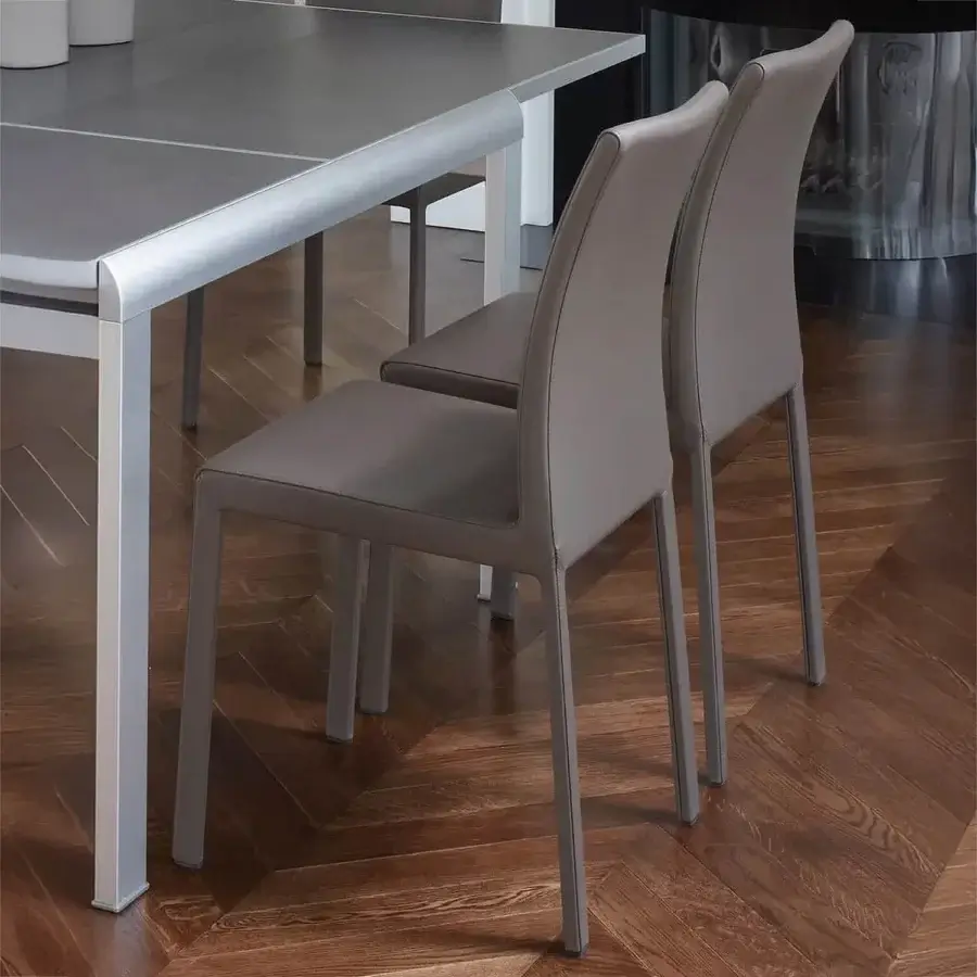 Distinguished Ivano Antonello Italia Lucy dining chair with steel and refined leather upholstery in muted taupe finish