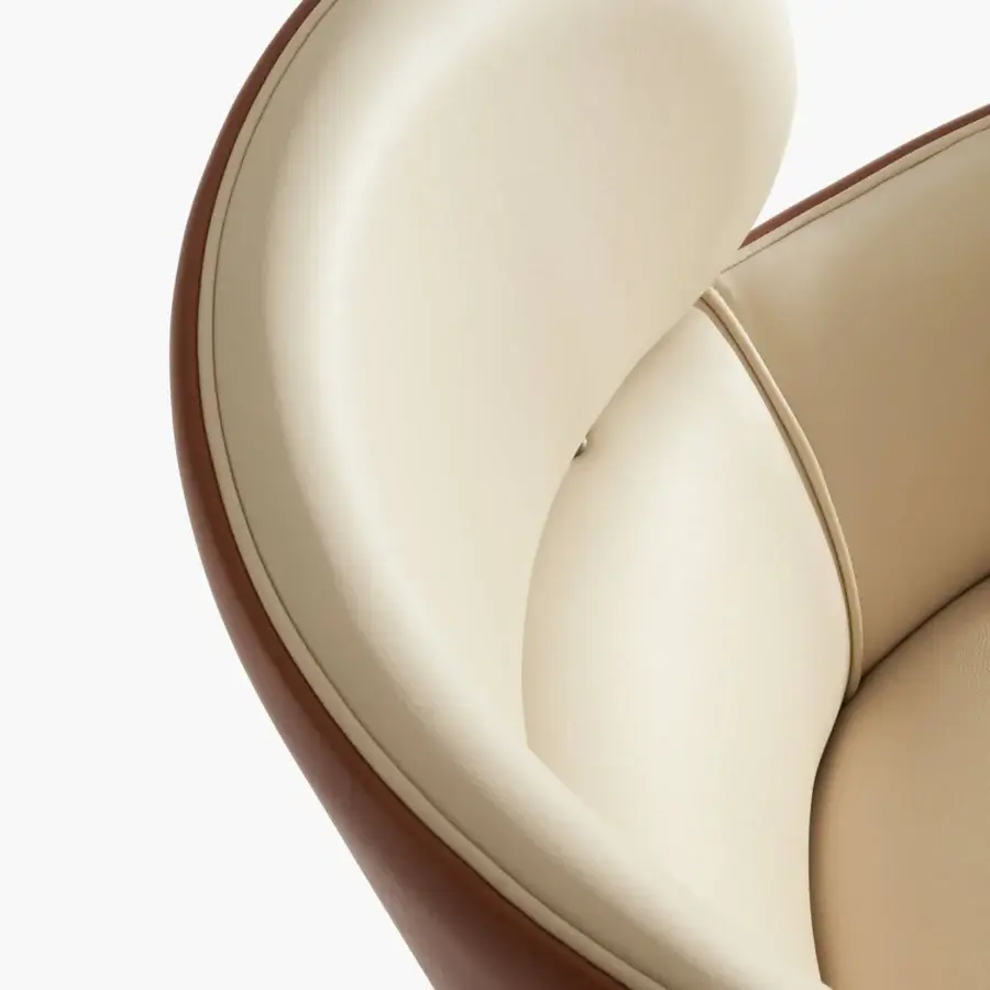 Lavish Capital Dafne lounge chair with enveloping form upholstered in pale beige leatherette and dark brown trim
