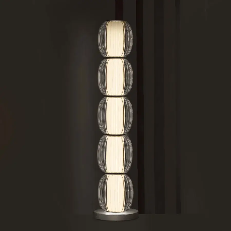 Exceptional Contardi Alma Totem floor lamp with stacked translucent modules and brushed metal base emitting a creamy white glow