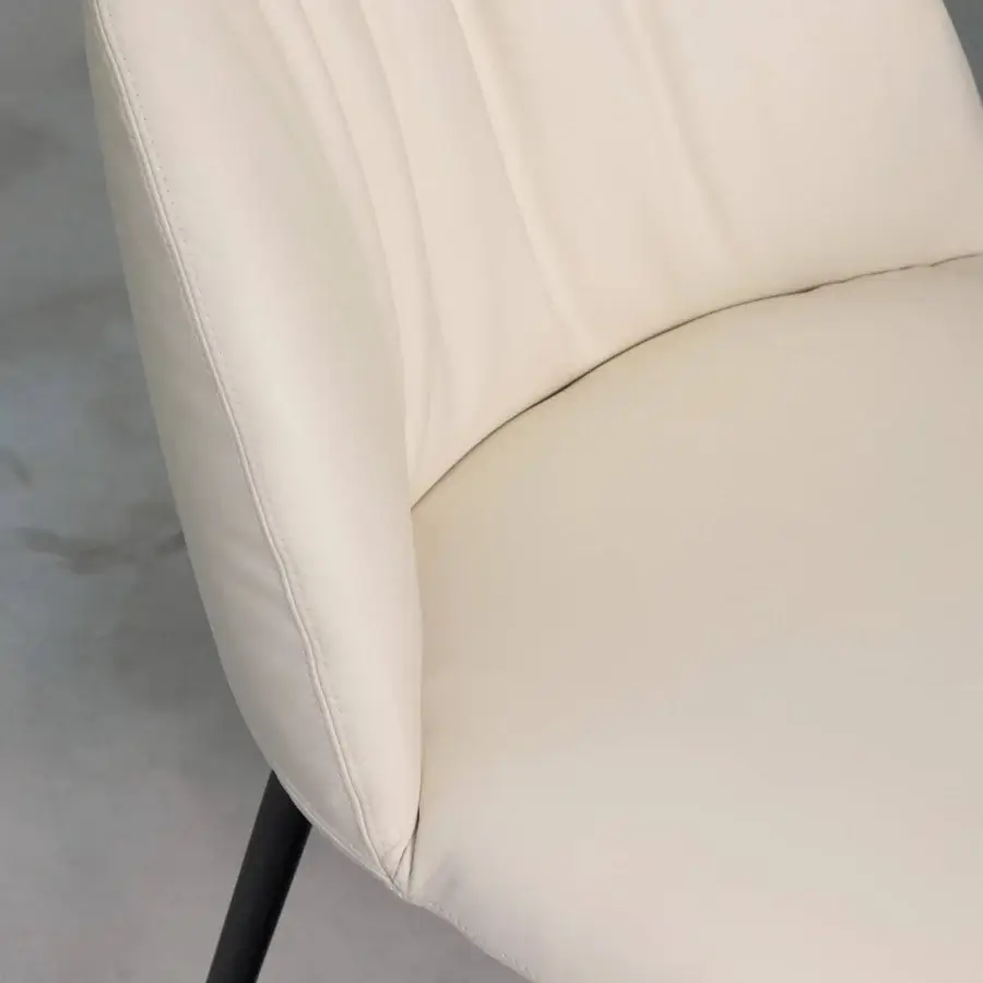 Sophisticated Tonin Casa Olympia chair upholstered in creamy off-white synthetic material with subtle vertical pleating and slender dark metal legs