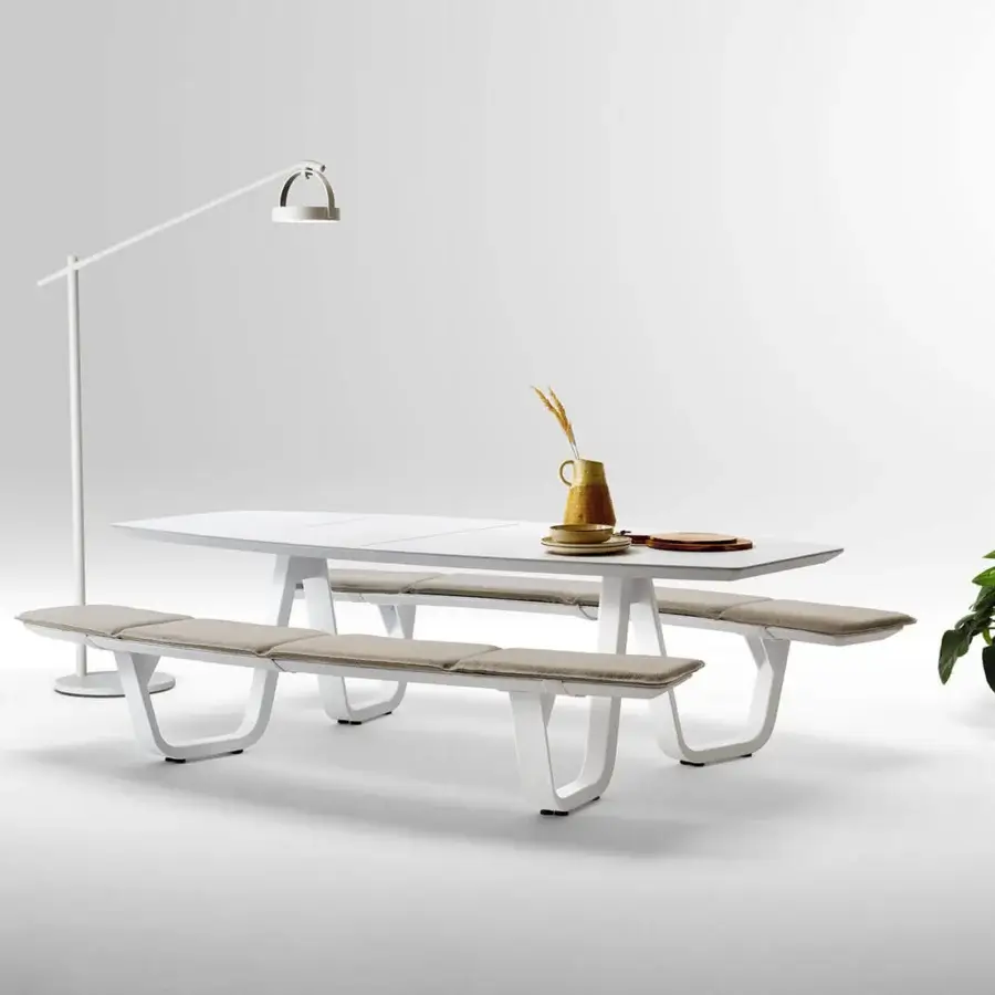 Elegant Atmosphera 8Teen table with benches crafted with satin white metal and white solid surface, featuring neutral gray padded seats