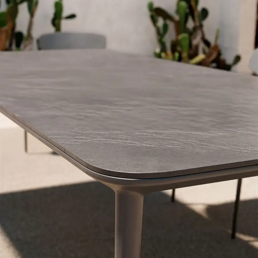 Superior Atmosphera Origami table with geometric silhouette and resilient gres porcelain stoneware in dark charcoal finish