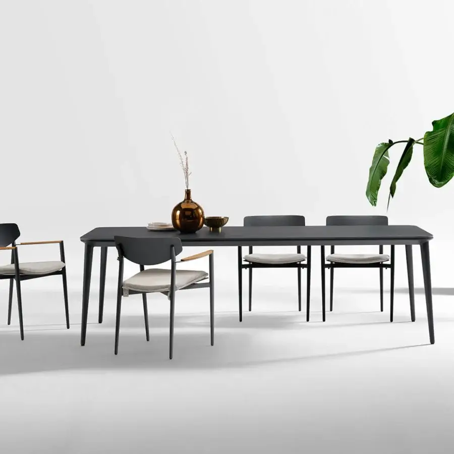 Elegant Atmosphera Origami table with folded silhouette and resilient gres porcelain stoneware in a dark gray matte finish