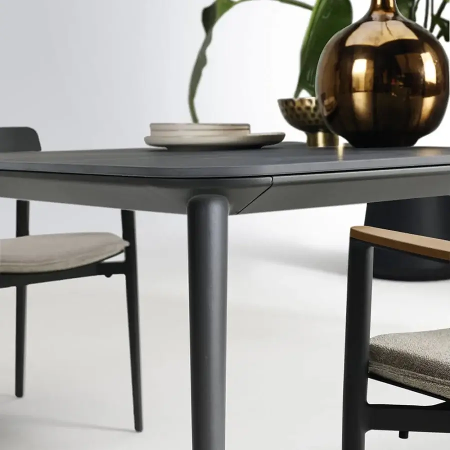 Exceptional Atmosphera Origami table with folded appearance and durable gres porcelain stoneware in dark gray matte finish