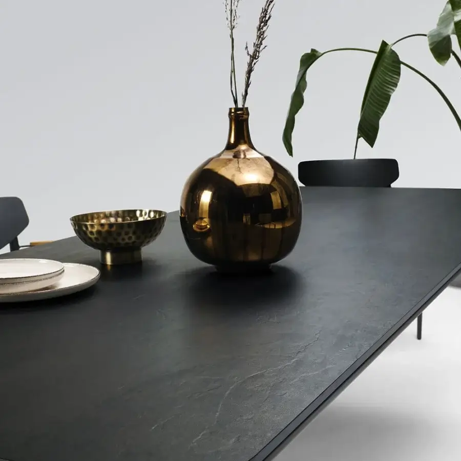Distinguished Atmosphera Origami table with angular silhouette and resilient gres porcelain stoneware in deep black finish